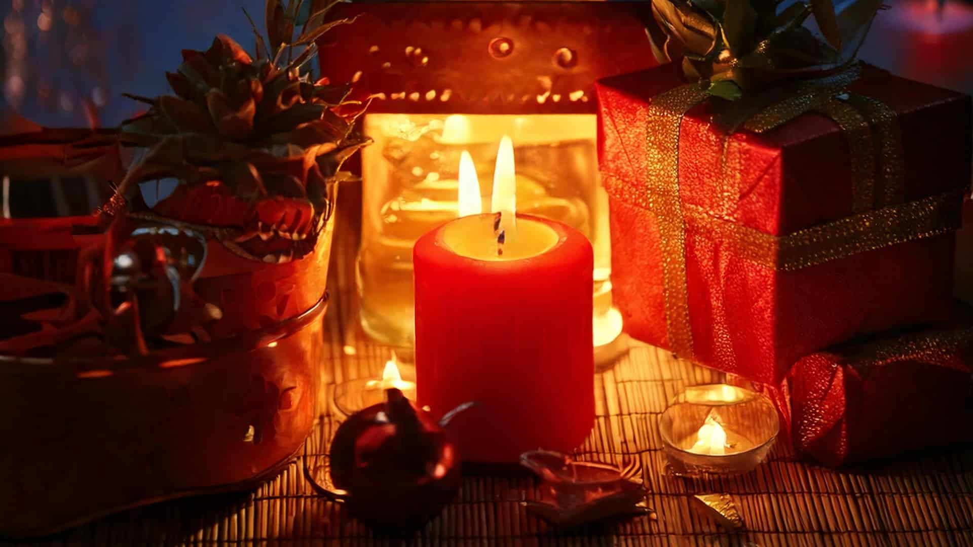 A warm, festive setting with a red candle burning brightly amidst decorative items. Surrounding the candle are wrapped gifts, small tealight candles, and shiny ornaments—proof that early holiday shopping ideas can transform any space into a cozy holiday atmosphere.